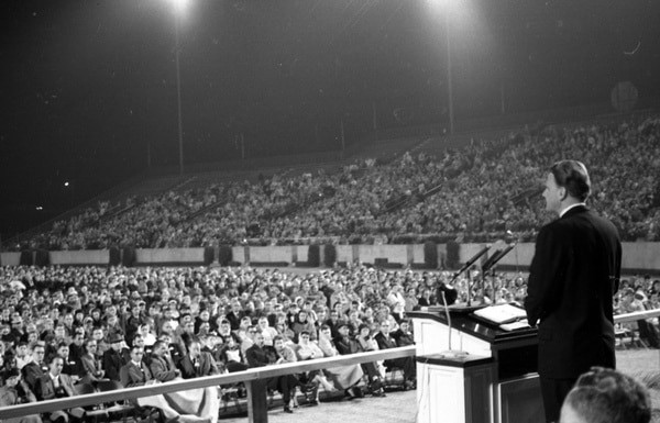 Billy Graham Quotes and him preaching to a crowd
