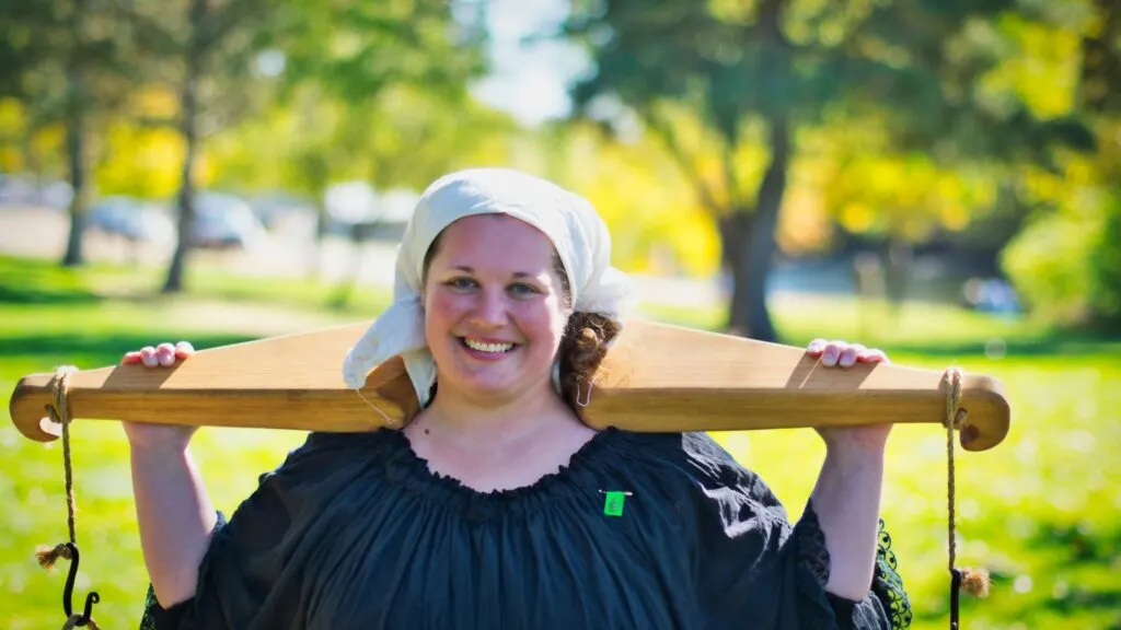 woman carrying a yoke