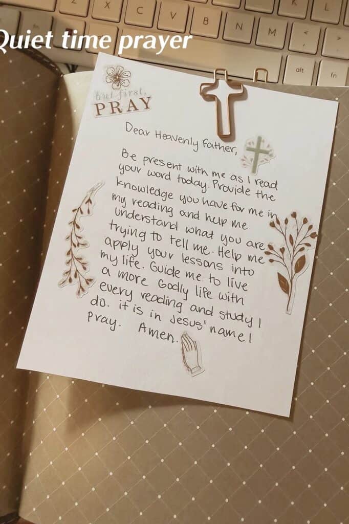Handwritten prayer note on Bible study, with cross clip and decorative elements.