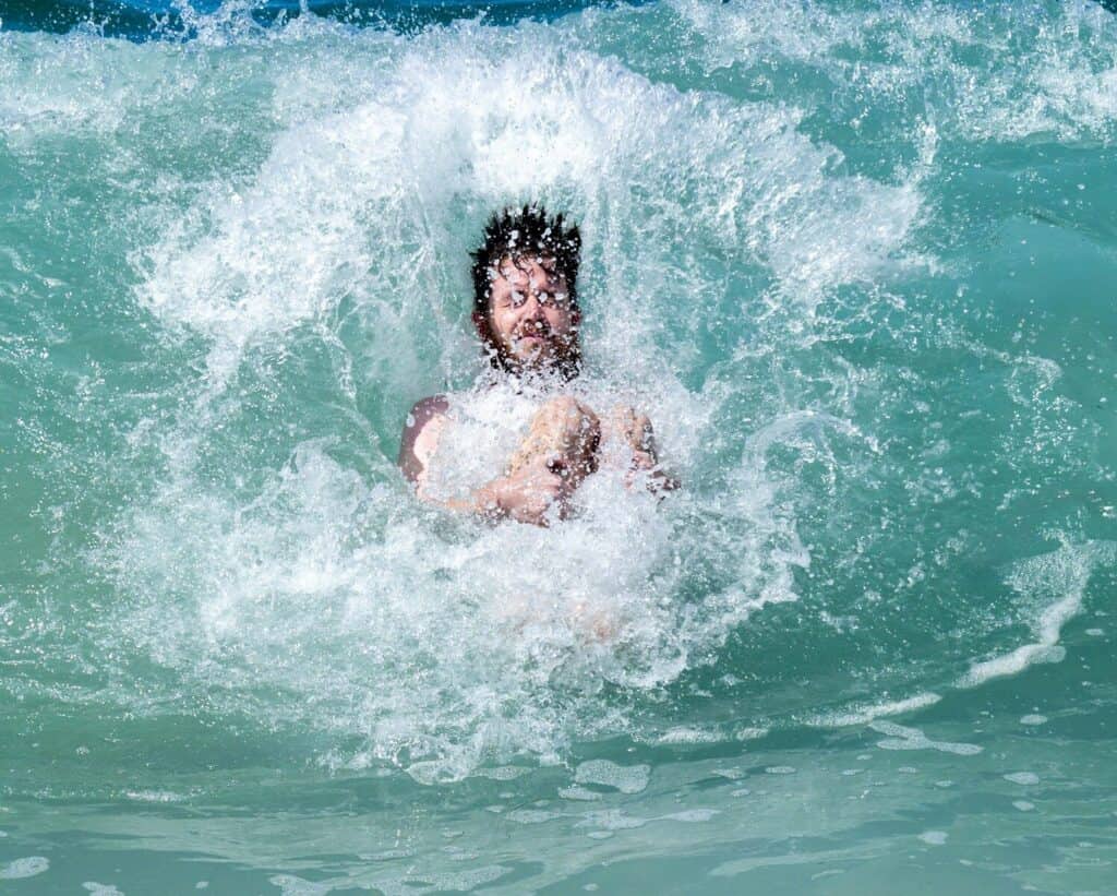 A person riding a wave on top of a surfboard