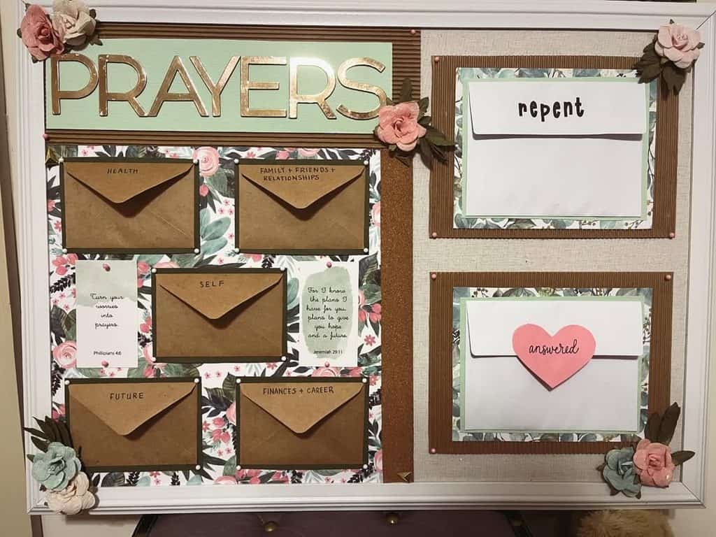 Decorative prayer and repentance bulletin board with envelopes and floral accents.