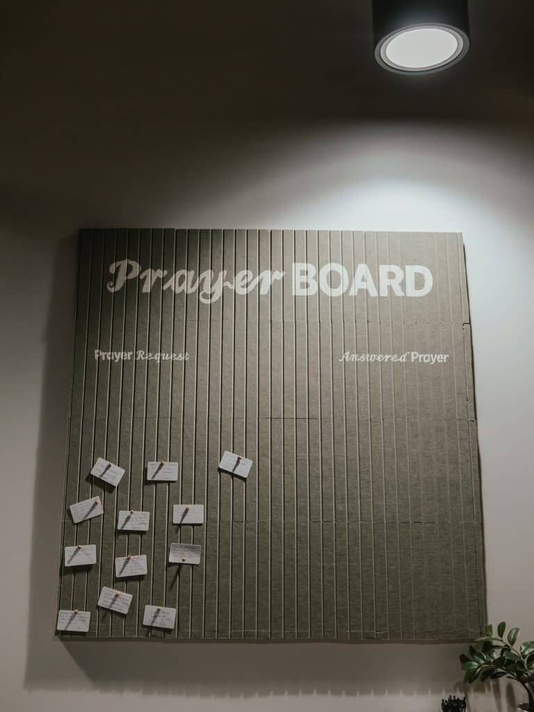 Large prayer board with envelopes for prayer requests and answered prayers.