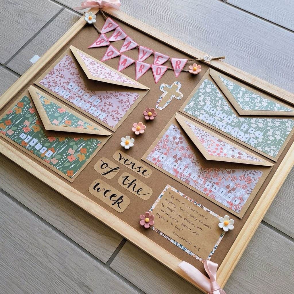 Decorative prayer board with envelopes, flowers, and inspirational messages for faith.
