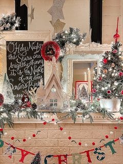 Festive Christmas decorations with lights, ornaments, and a chalkboard message.